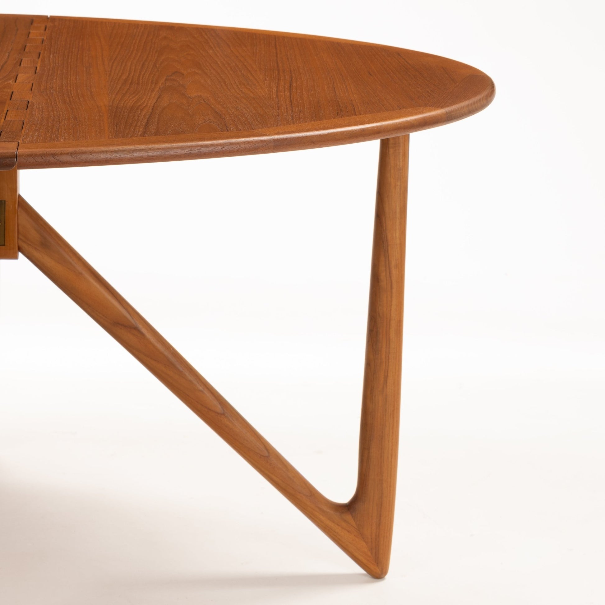 Kurt Ostervig Drop-Leaf Dining Table close view of rounded wood top and distinctive angled support leg with warm grain in mid century modern furniture style