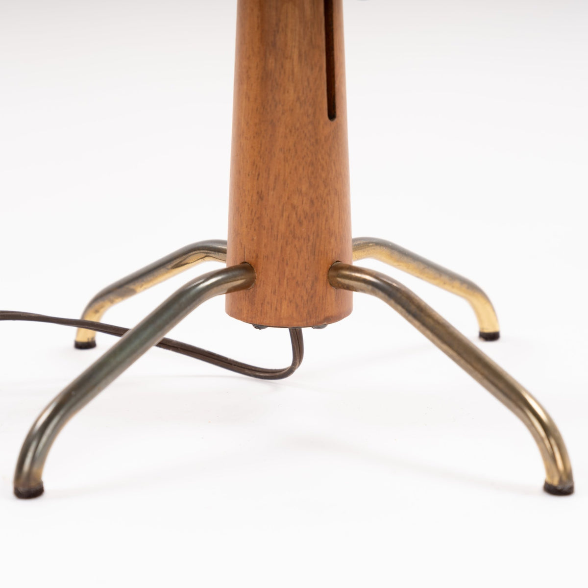 Manner of Josef Frank Table Lamp closeup showing tapered wood stem inset adjustment slot curved polished metal tripod legs and cord in mid century modern lighting