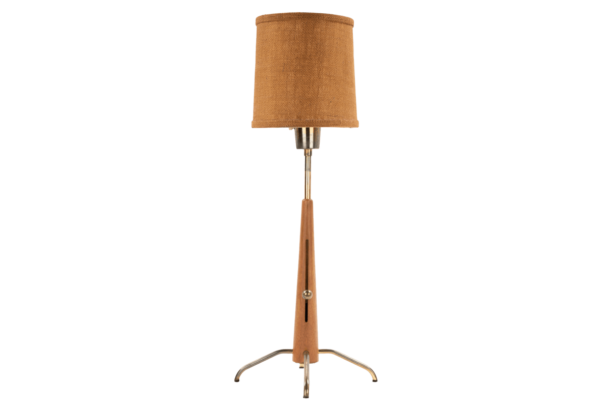 Manner of Josef Frank Table Lamp with slender wood stem linen drum shade and polished metal tripod base in mid century modern lighting