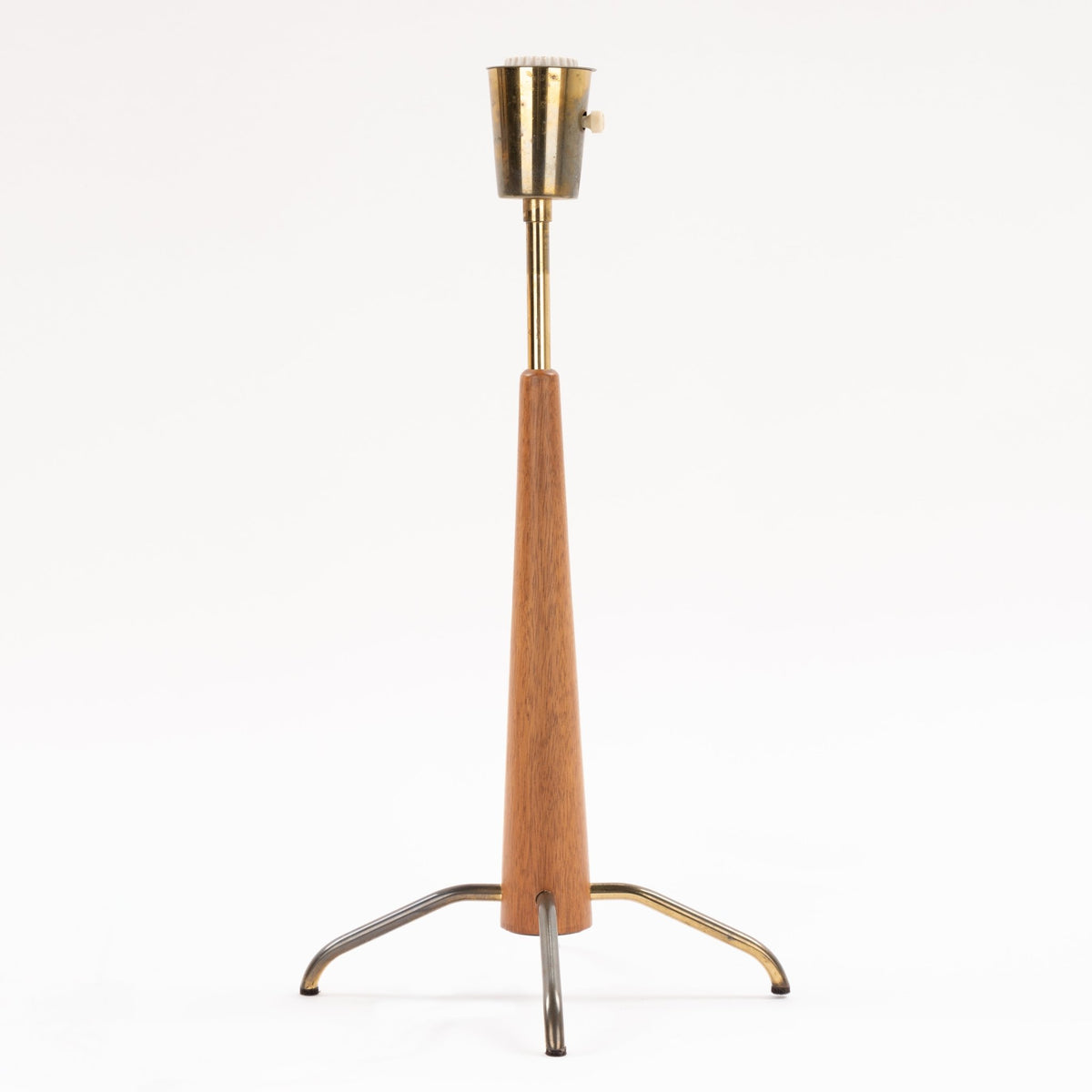Manner of Josef Frank Table Lamp with tapered wood stem exposed metal socket and curved tripod legs in mid century modern lighting