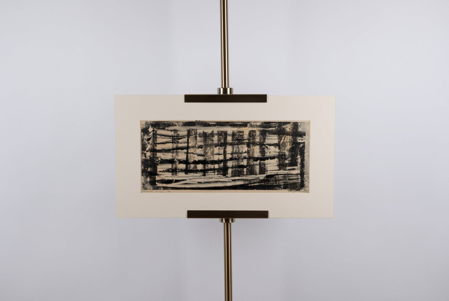 Margot Kempe abstract monotype print titled "United" with black textured lines on beige matting displayed on stand