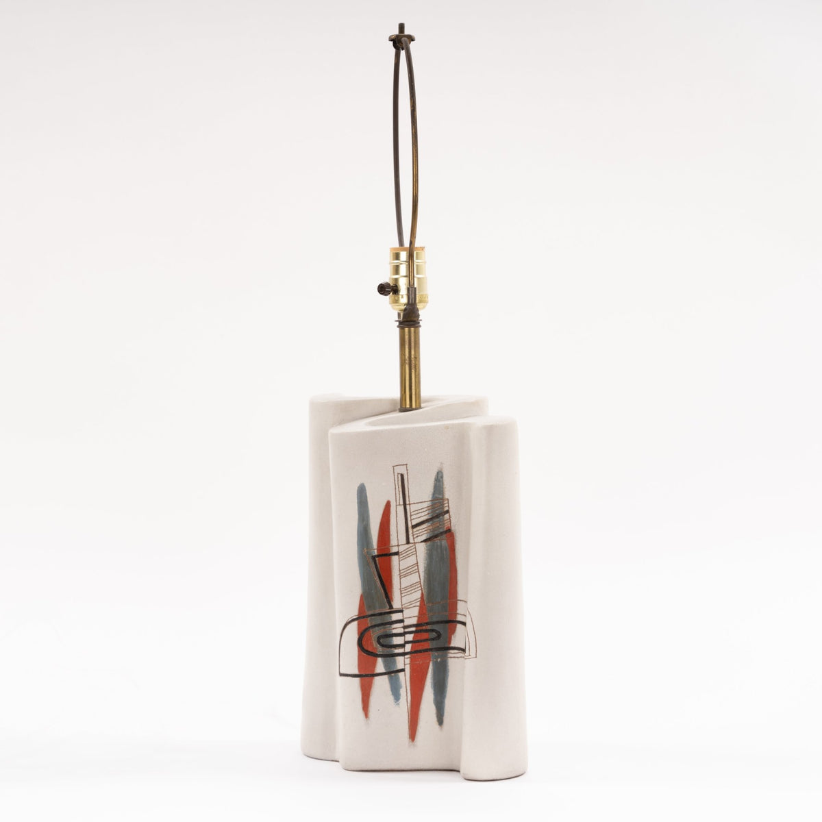 Marianna Von Allesch Table Lamp with a white ceramic sculptural base and abstract red blue and black motif with exposed brass socket in mid century modern lighting