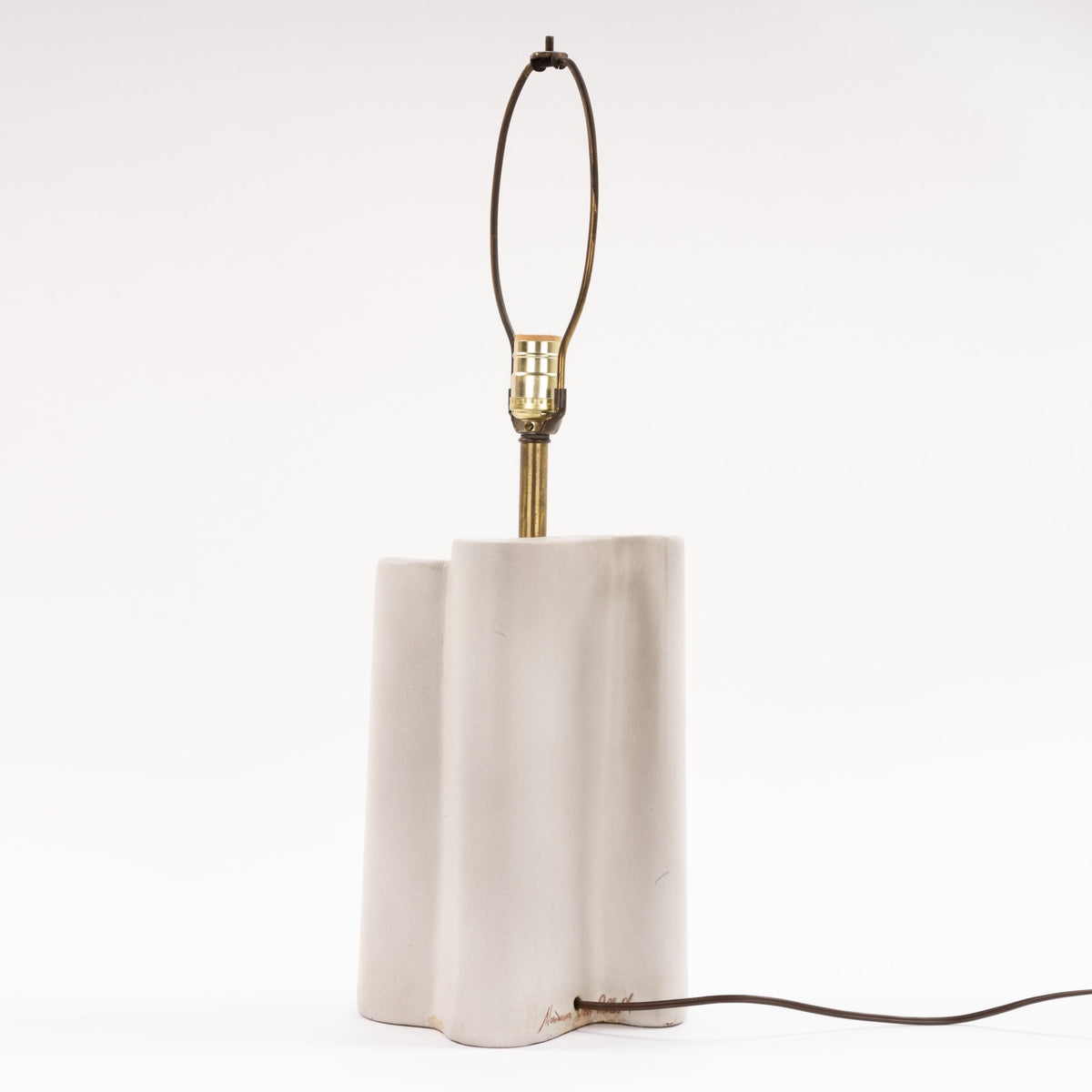 Marianna Von Allesch Table Lamp with a softly textured white sculptural ceramic base brass stem and exposed socket in minimalist mid century modern lighting