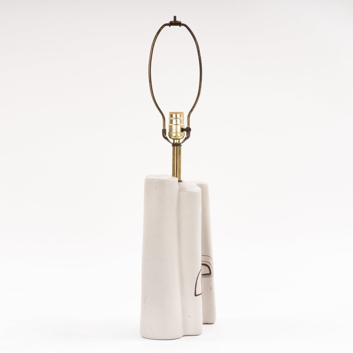 Marianna Von Allesch Table Lamp with a sculptural white ceramic base brass stem and exposed socket in minimalist mid century modern lighting