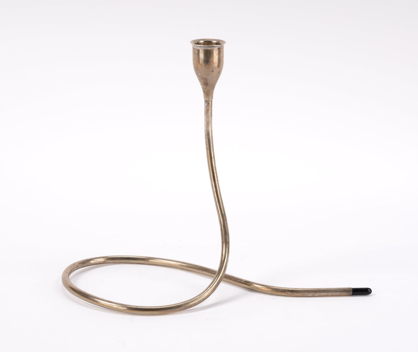 1950s Marion Anderson sterling silver candlestick with curved tubular form and black plastic tip on white background