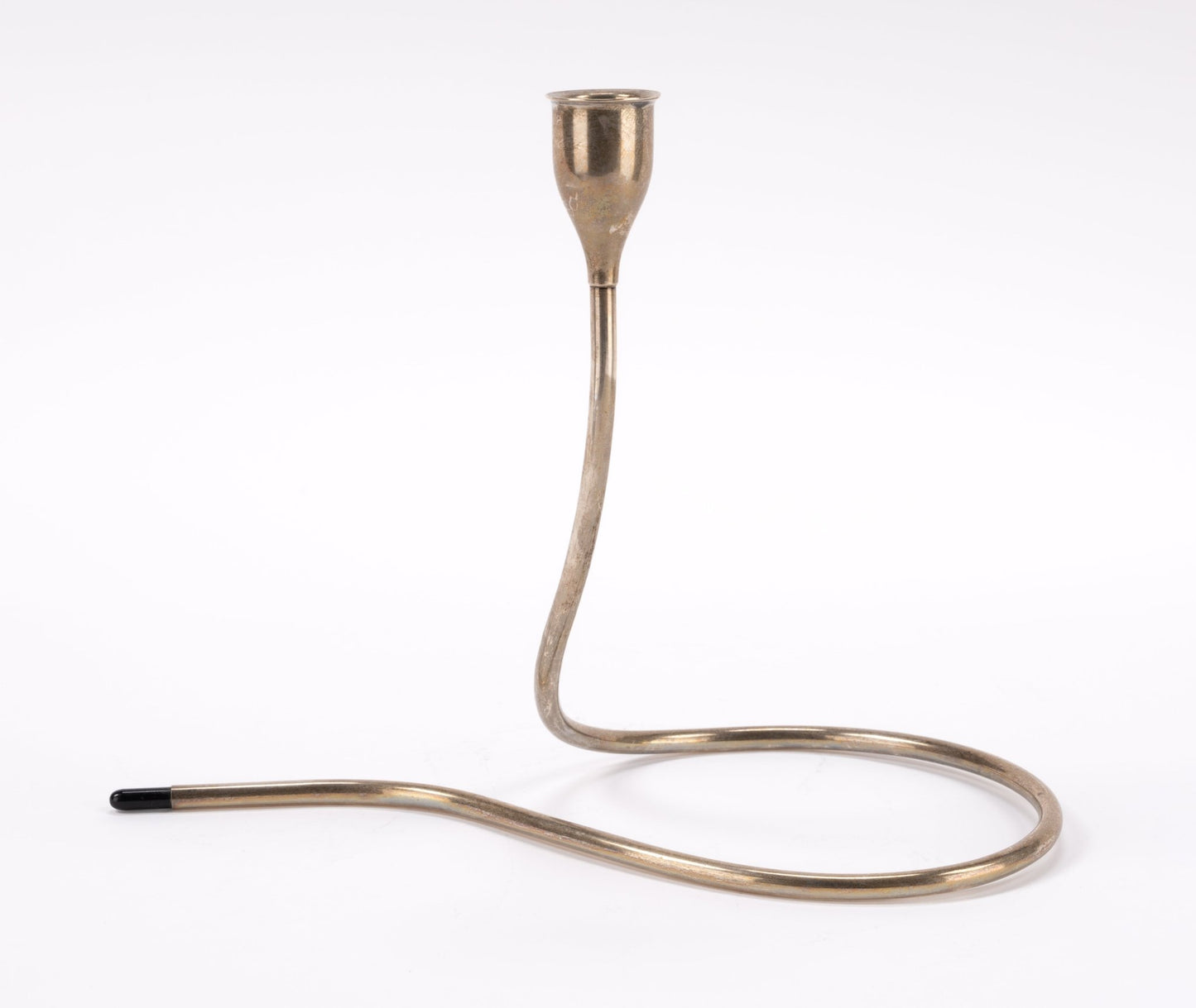 1950s Marion Anderson sterling silver candlestick with curved tubular form and black plastic tip on white background