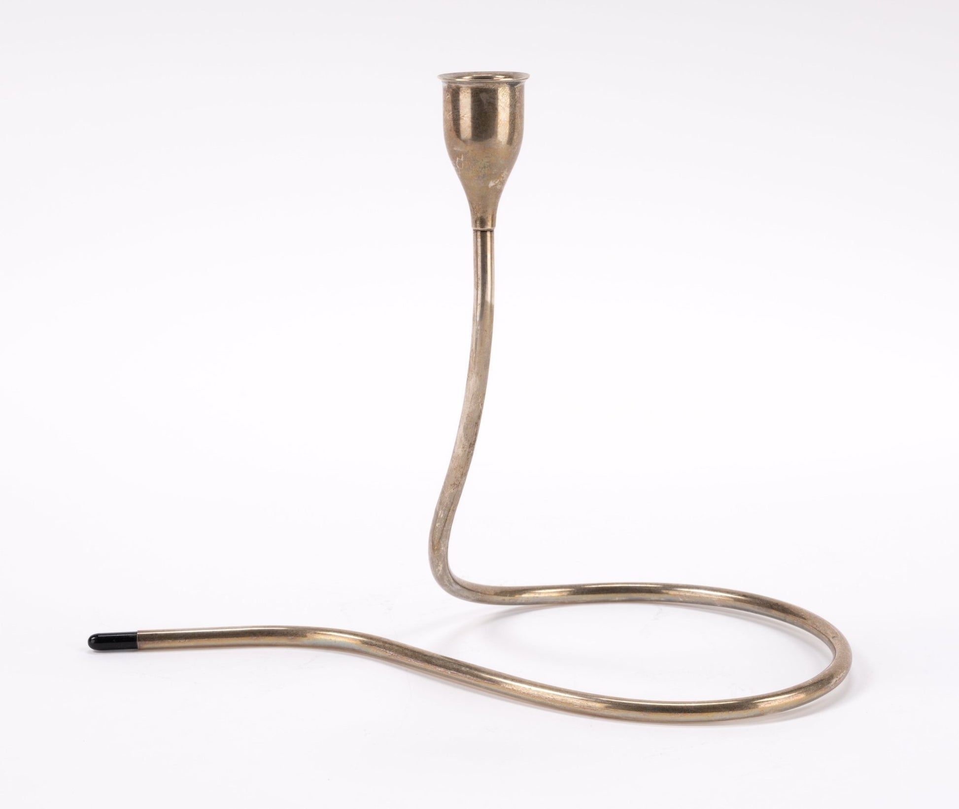1950s Marion Anderson sterling silver candlestick with curved tubular form and black plastic tip on white background