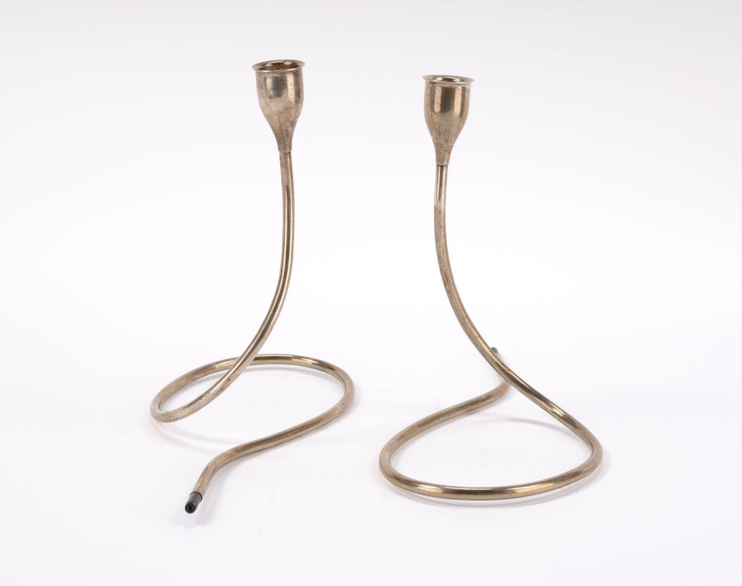 Pair of mid-century modern Marion Anderson sterling silver candlesticks with curved looping bases and plastic tips