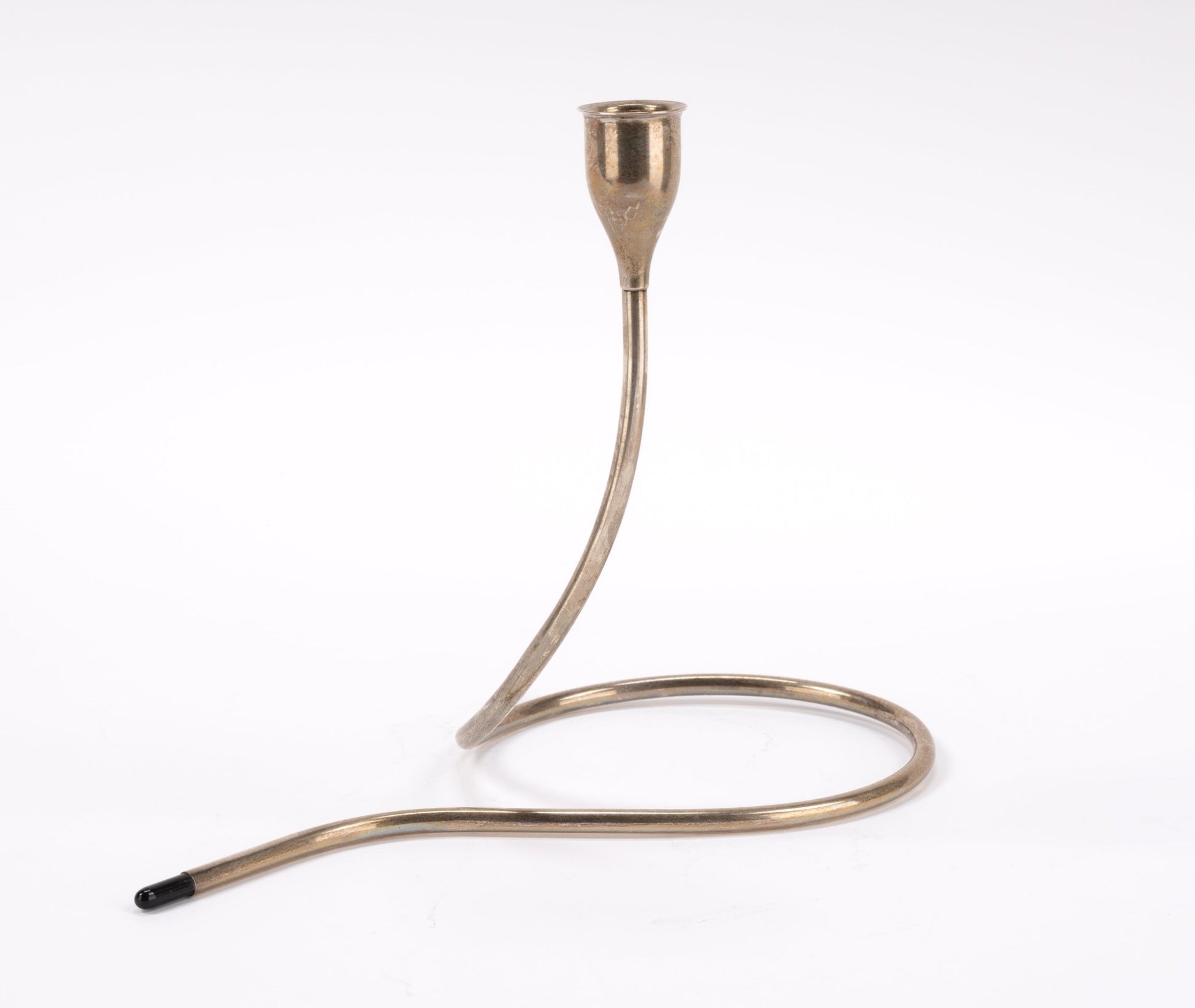Mid-century sterling silver candlestick with curved tubular form and black plastic tip on white background