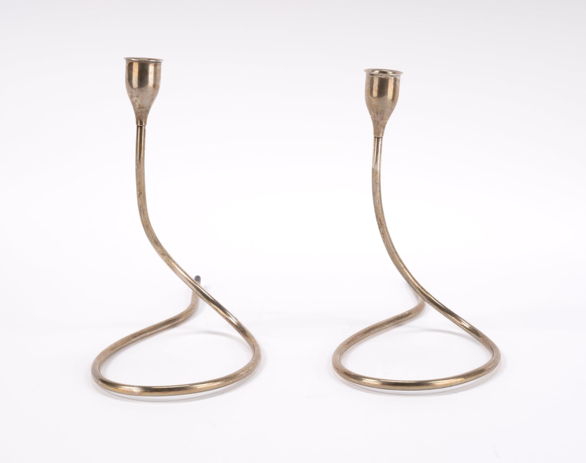 Pair of sterling silver Marion Anderson candlesticks with curved tubular design and plastic accents on white background