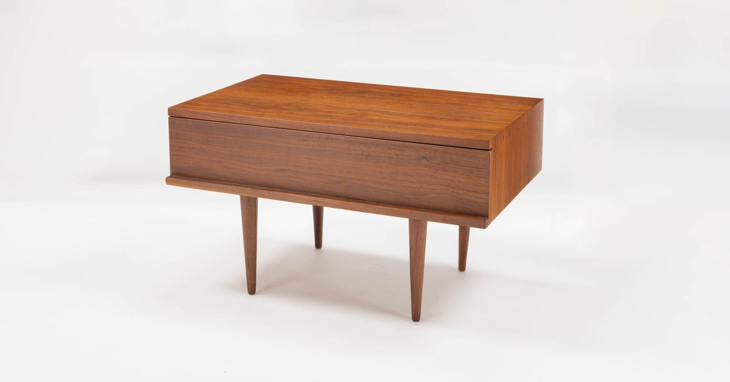 Mid-century modern walnut side table by Mel Smilow with rectangular form, single drawer, and tapered legs