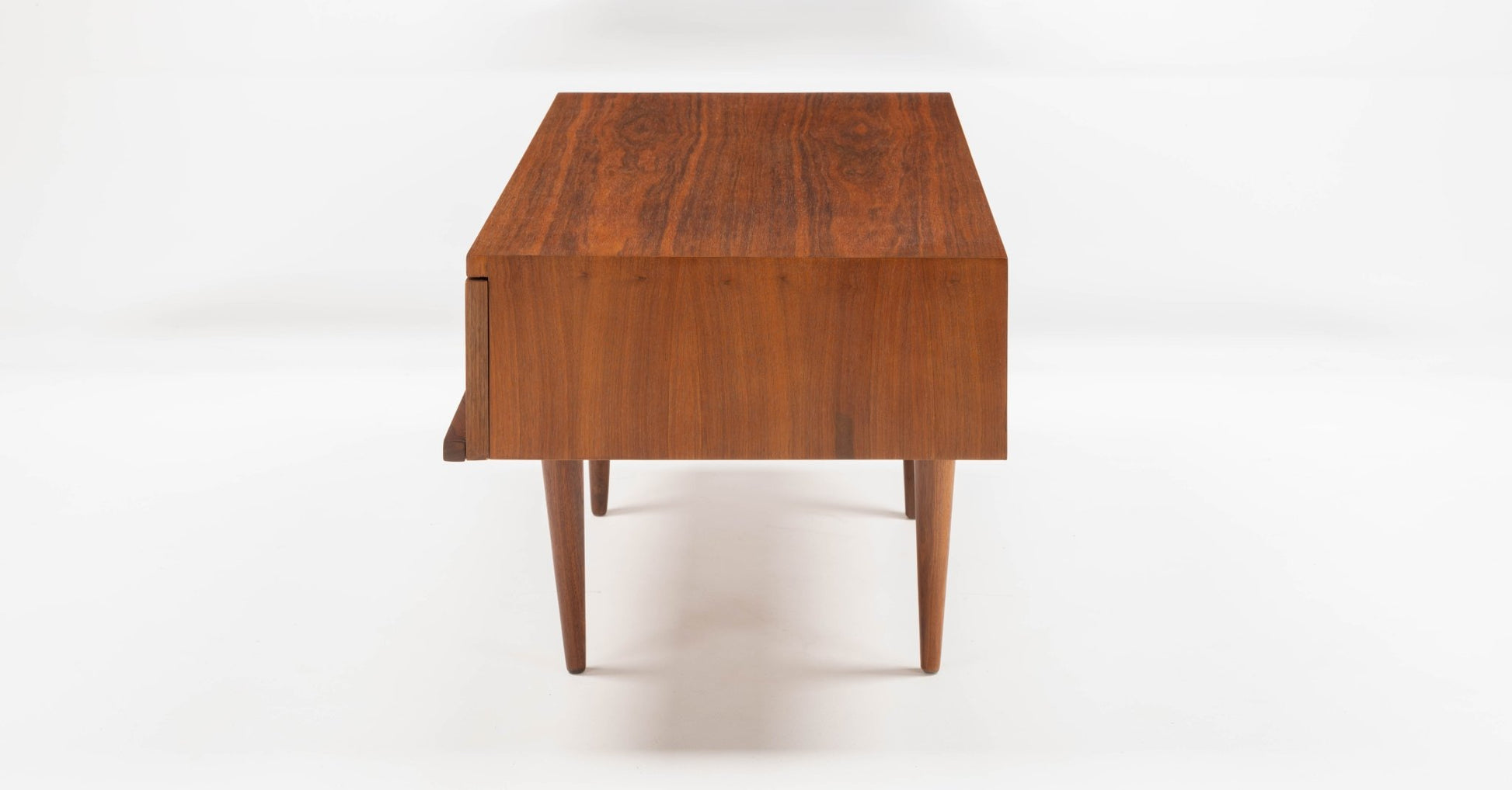 Pair of mid-century modern walnut side tables with rectangular tops, single front drawers, and tapered legs