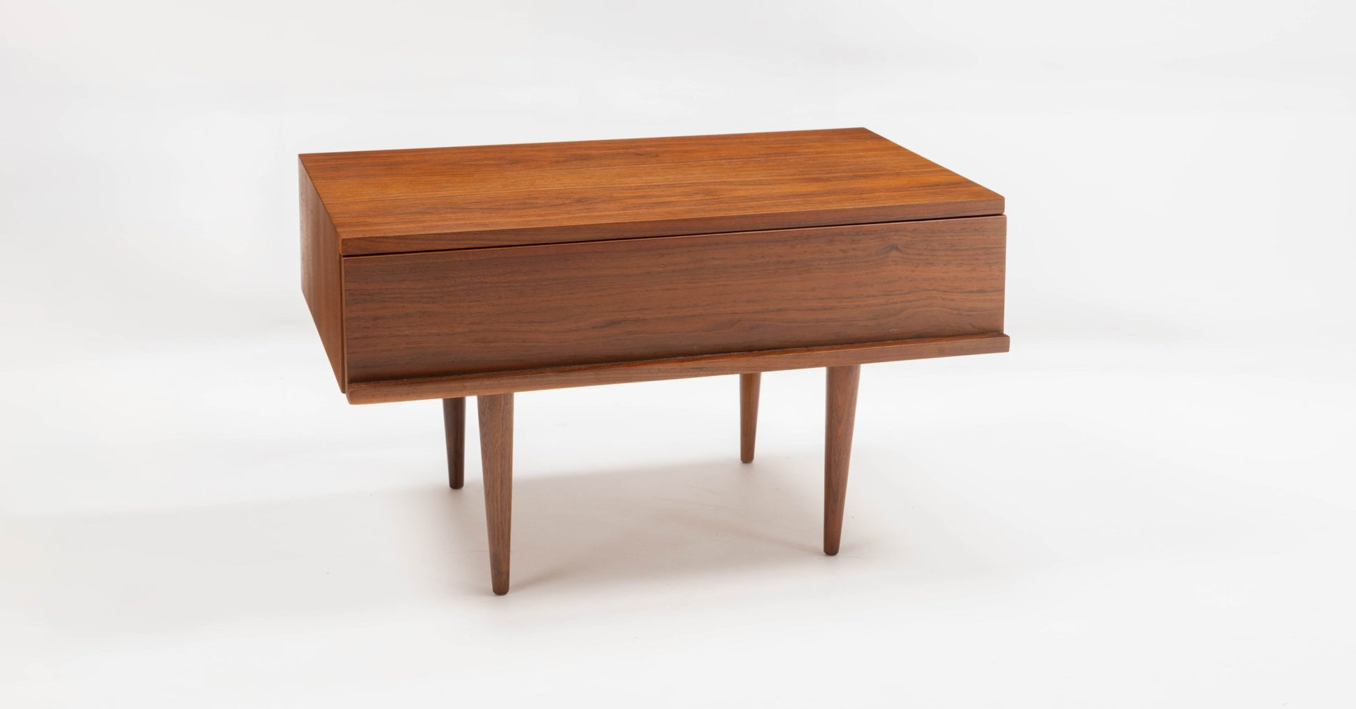 Mid-century modern walnut side table with rectangular top, single drawer, and tapered legs designed by Mel Smilow.