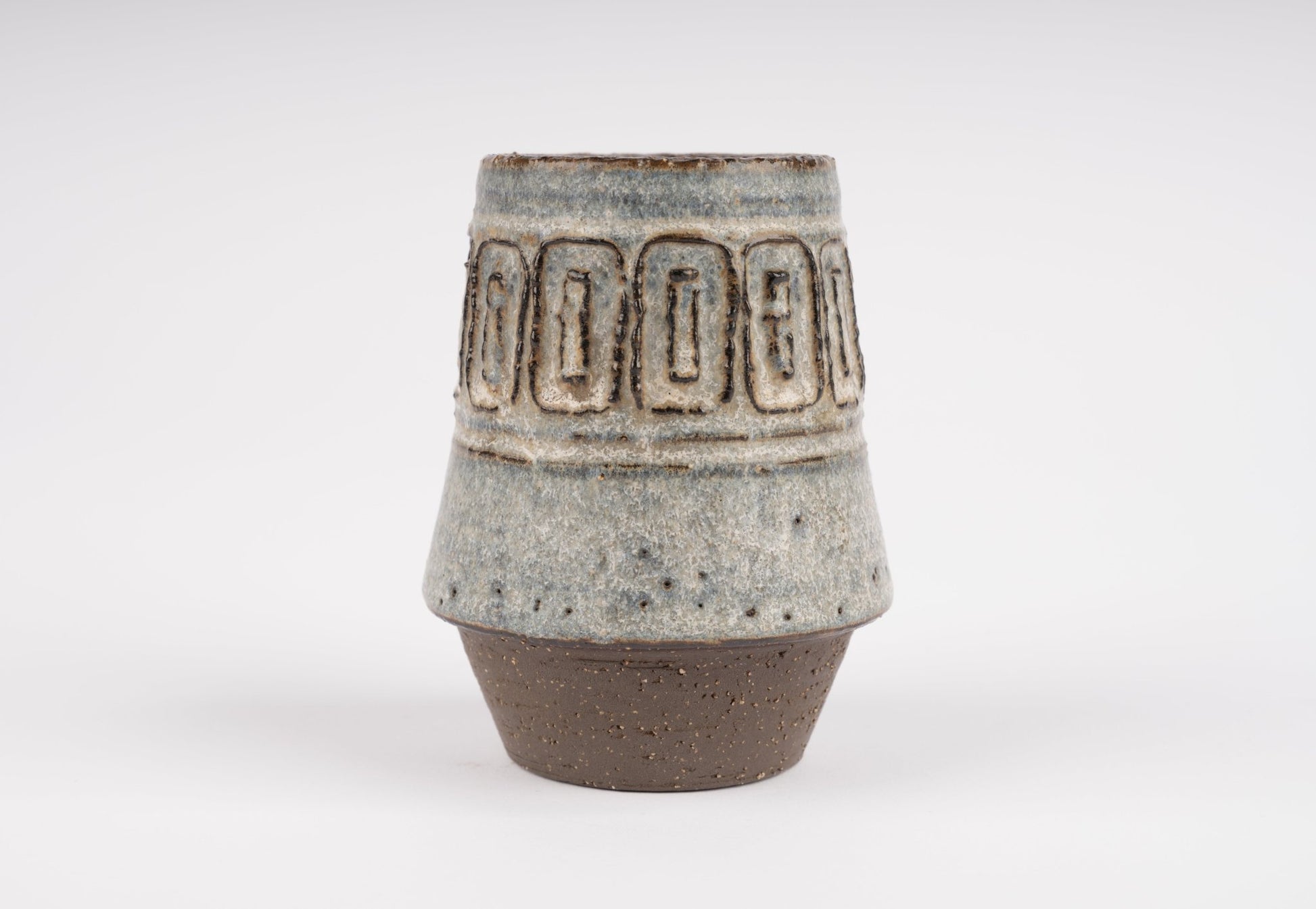 Michael Andersen stoneware vase with carved geometric band and textured glaze on tapered brown ceramic base