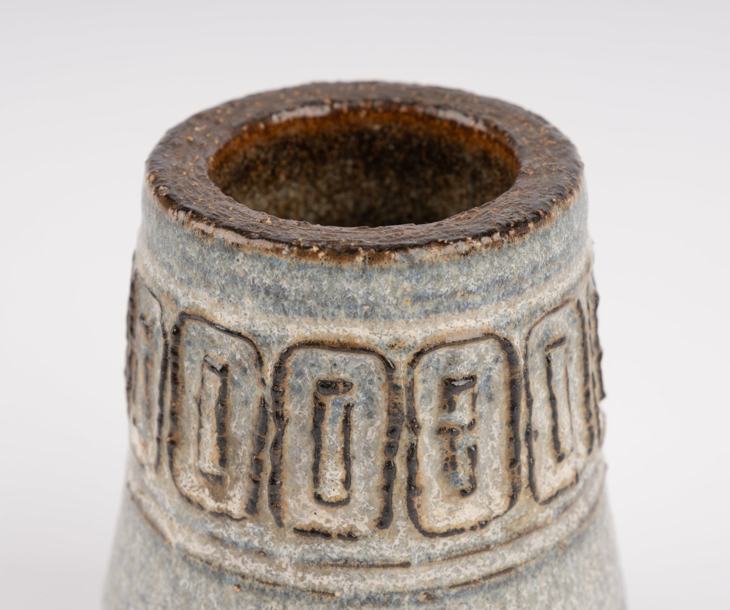 Close-up of Michael Andersen stoneware vase with carved geometric relief band and textured glaze finish