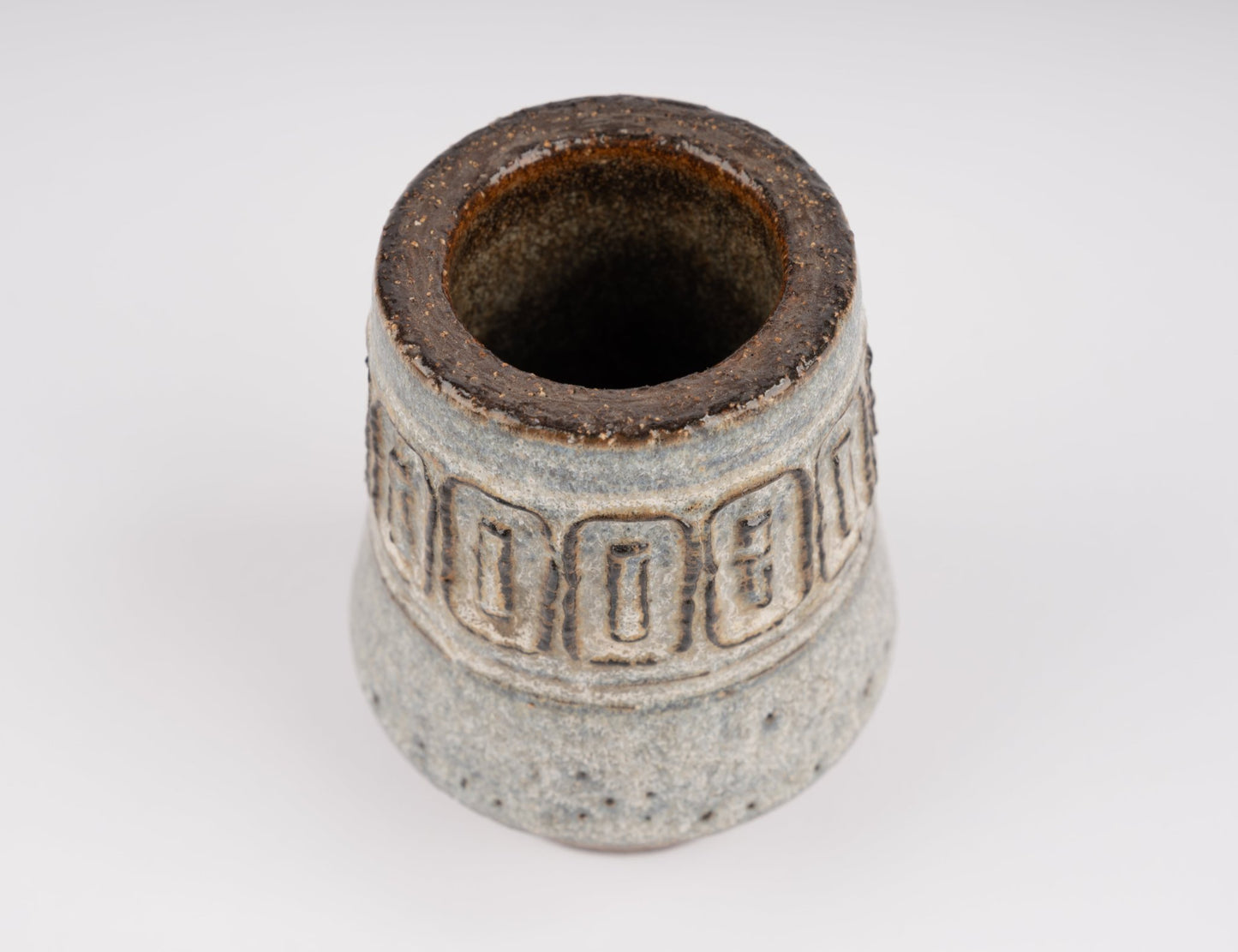 Top view of Michael Andersen stoneware vase with carved geometric relief band and textured glaze surface