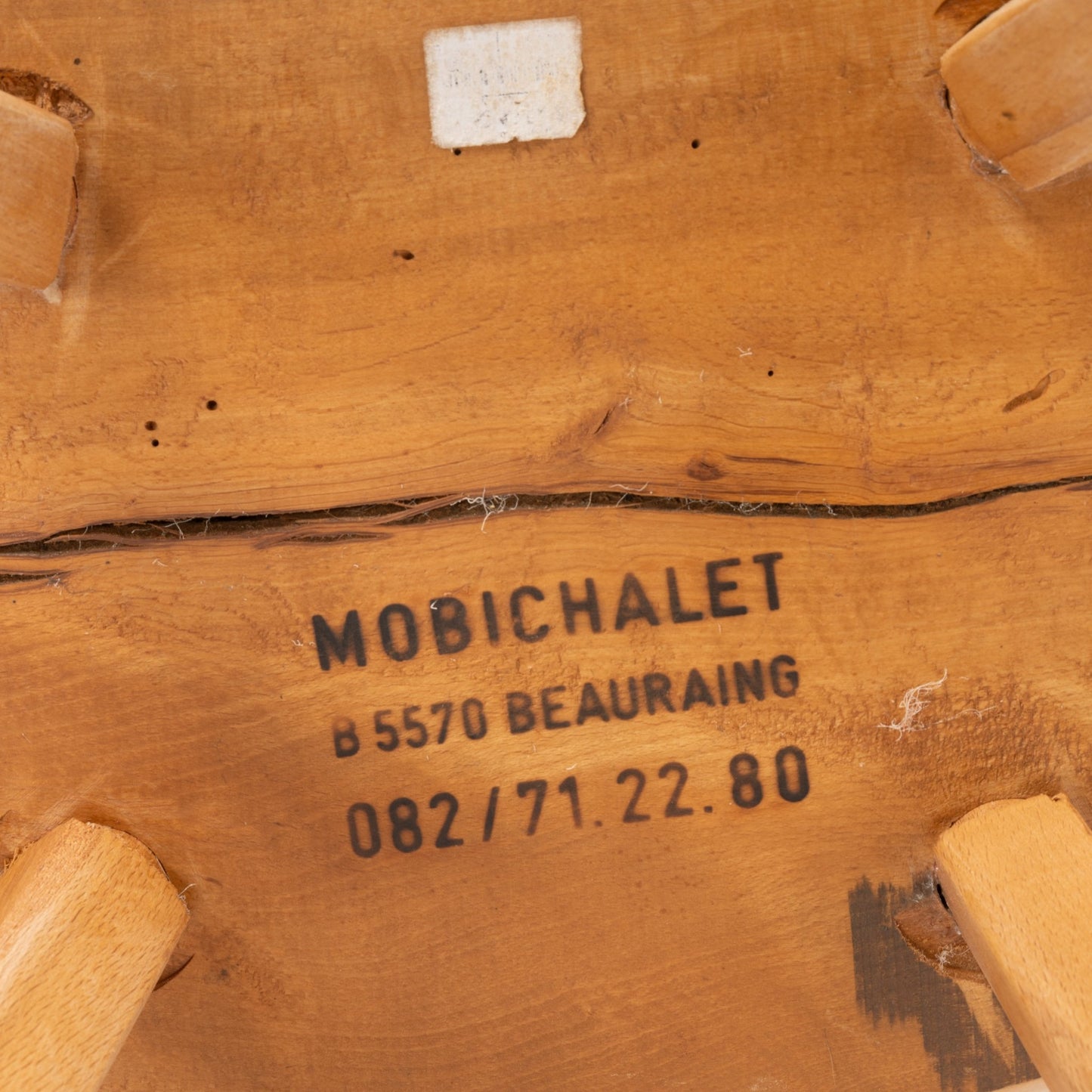 Close-up of underside Mobichalet pine chair stamped with maker's mark and Belgium Beauraing location from 1950s