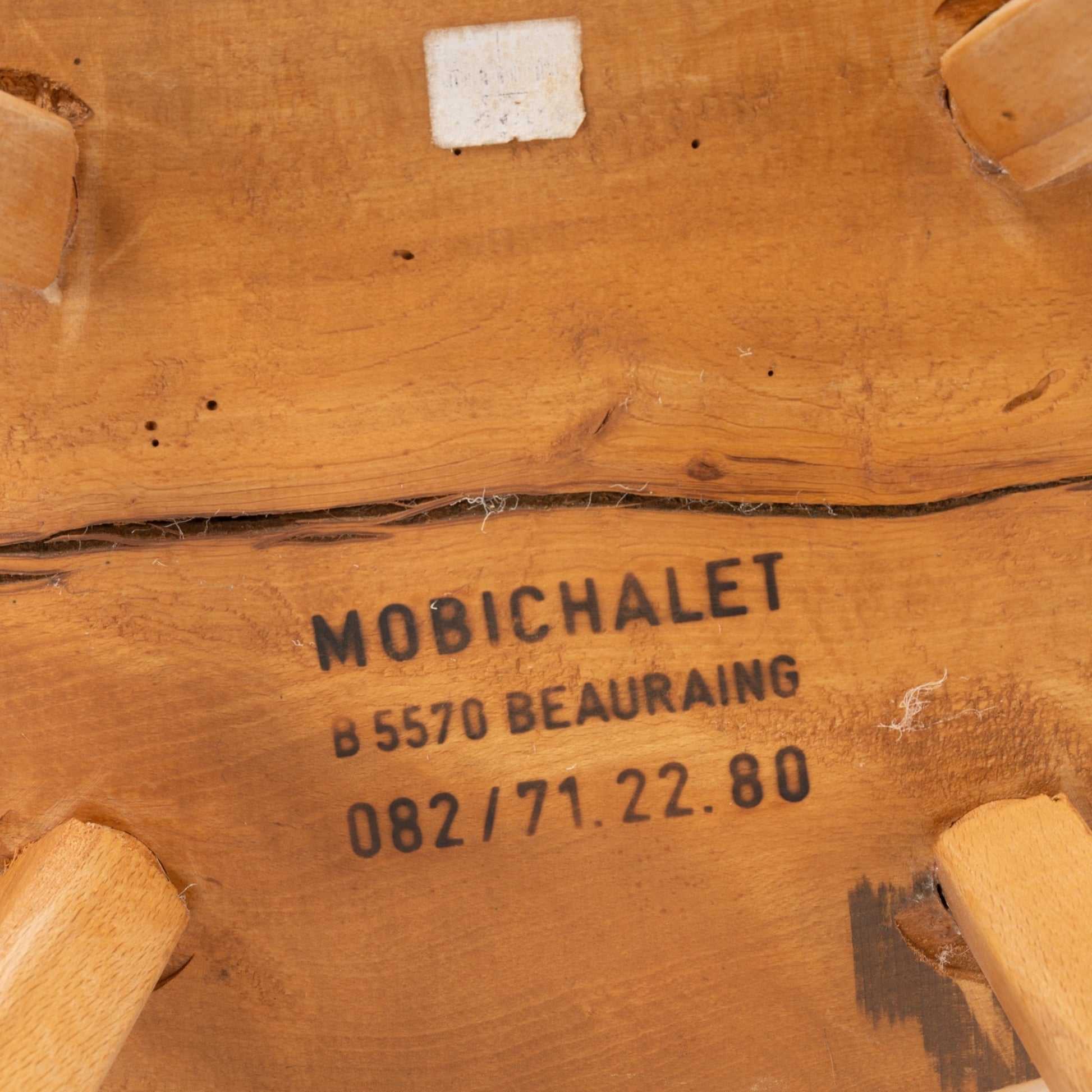 Close-up of underside Mobichalet pine chair stamped with maker's mark and Belgium Beauraing location from 1950s
