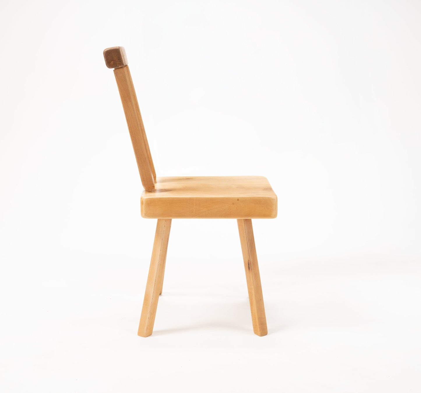 Side view of Mobichalet Brutalist pine chair with oversized seat and simple angled backrest on white background