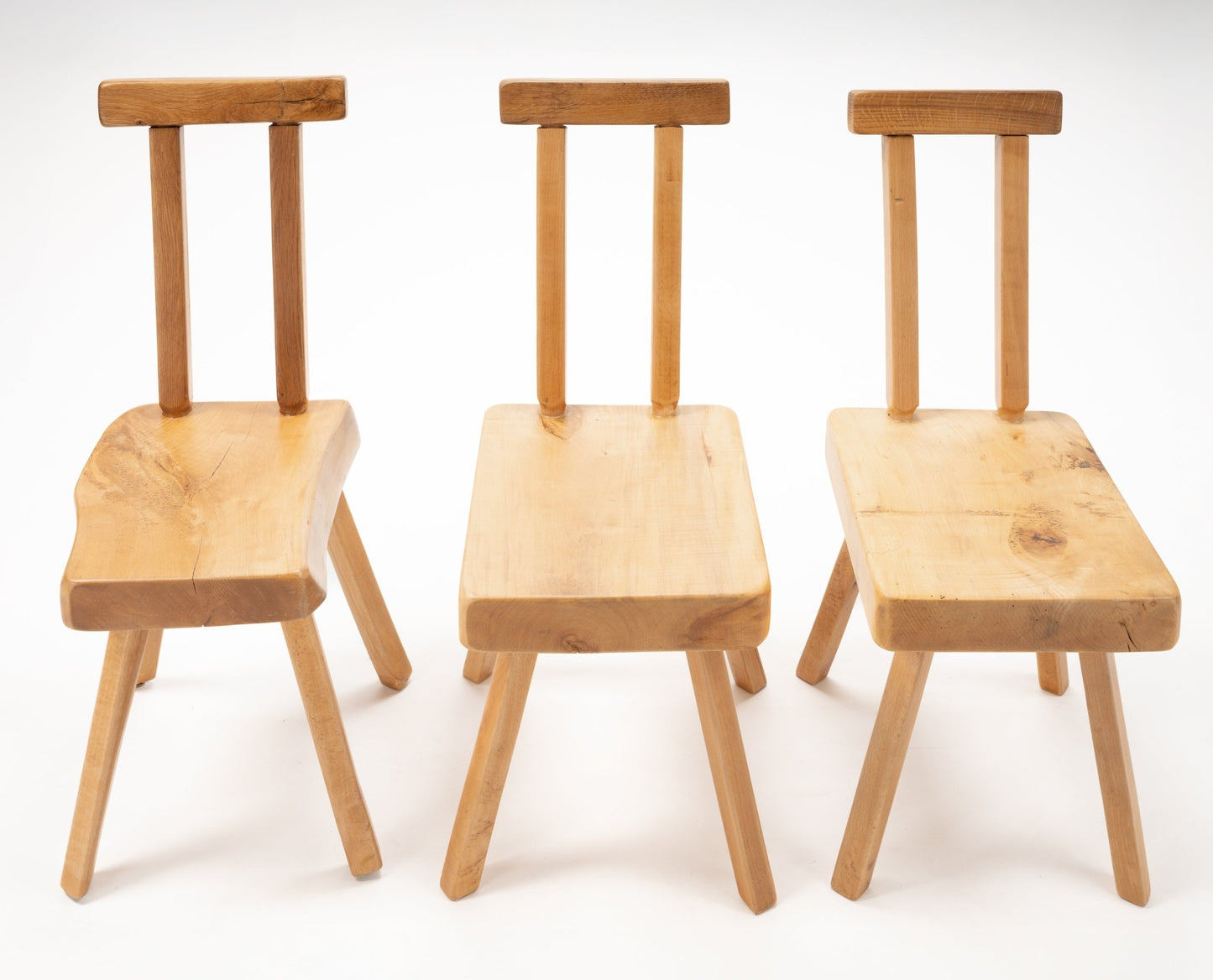 Set of three Mobichalet Brutalist oversized pine chairs with simple backrests and angled legs on white background