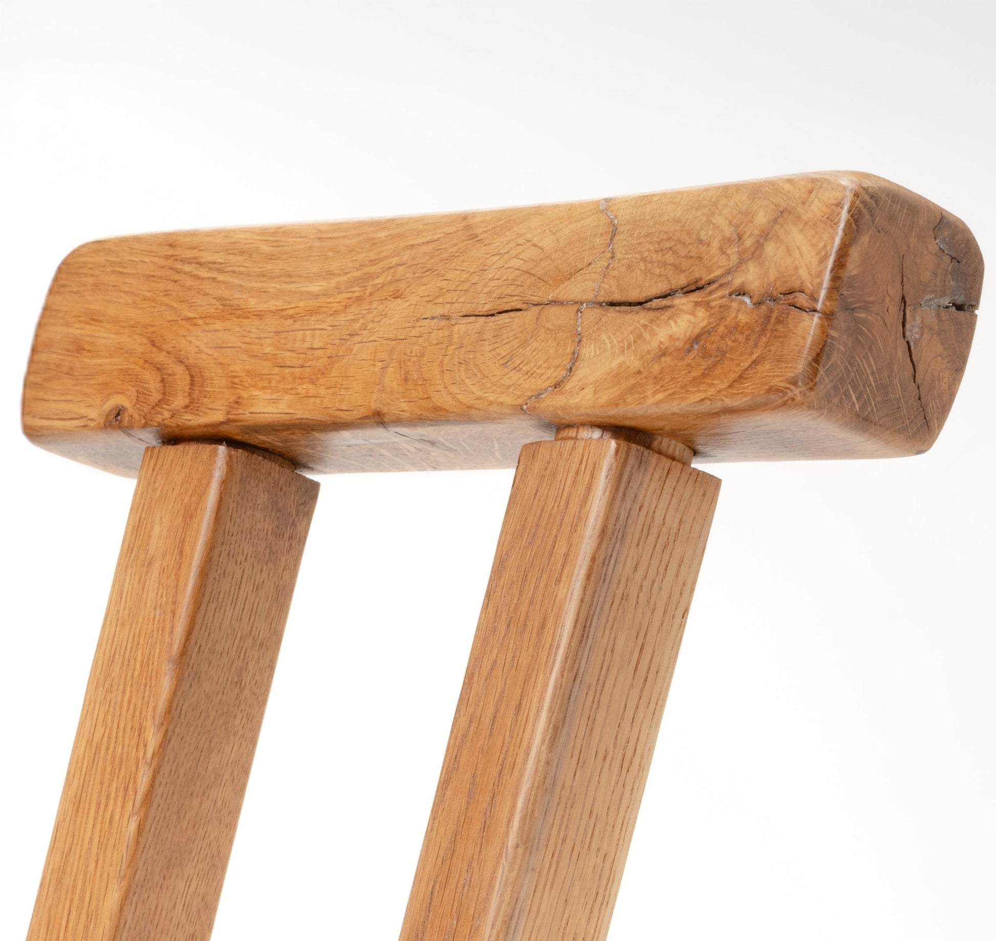 Close-up of Mobichalet Brutalist pine chair showing thick carved wood with natural grain and rustic cracks