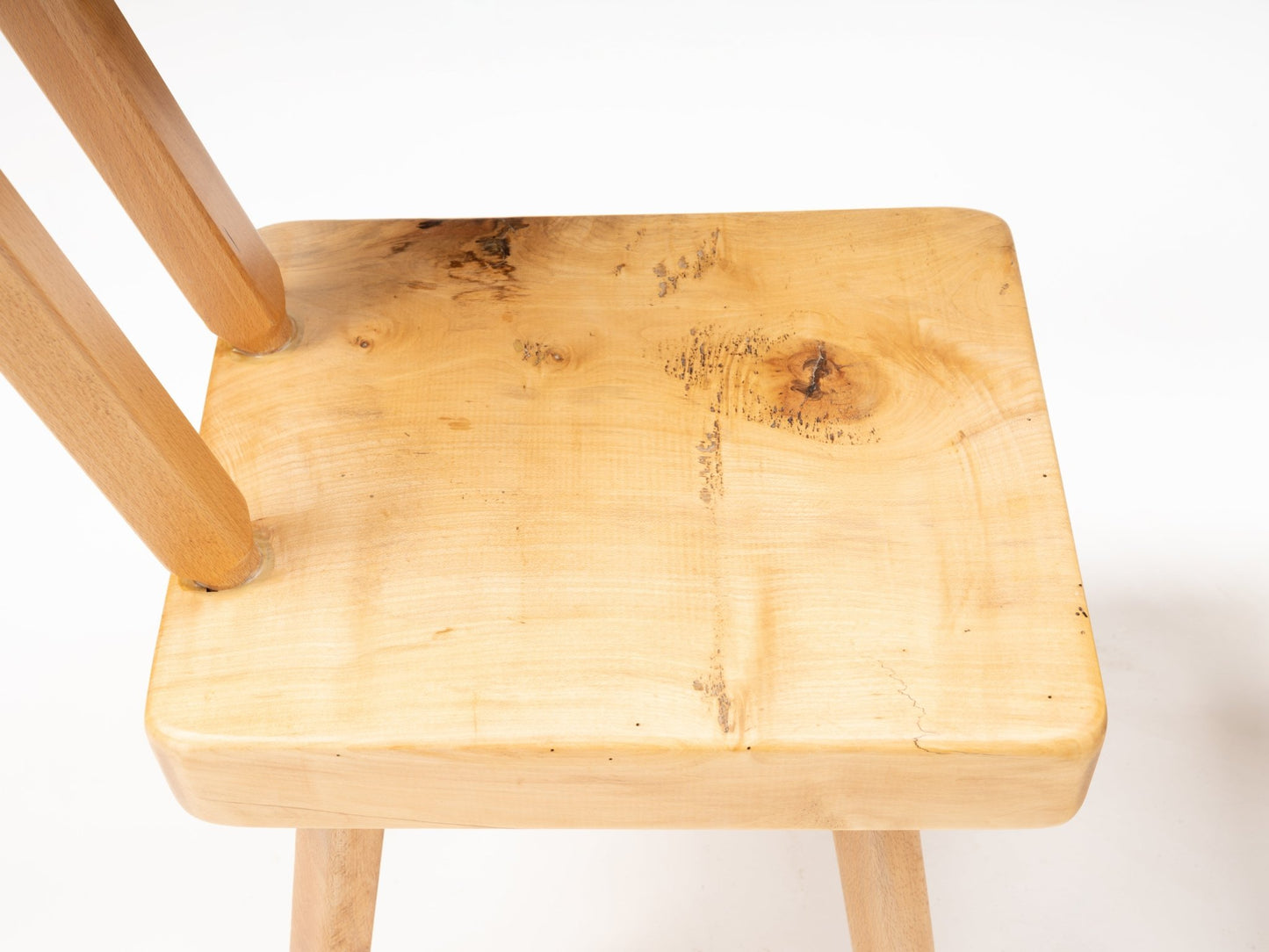 Close-up of Mobichalet Brutalist pine chair seat showing natural wood grain and craftsmanship from Belgium