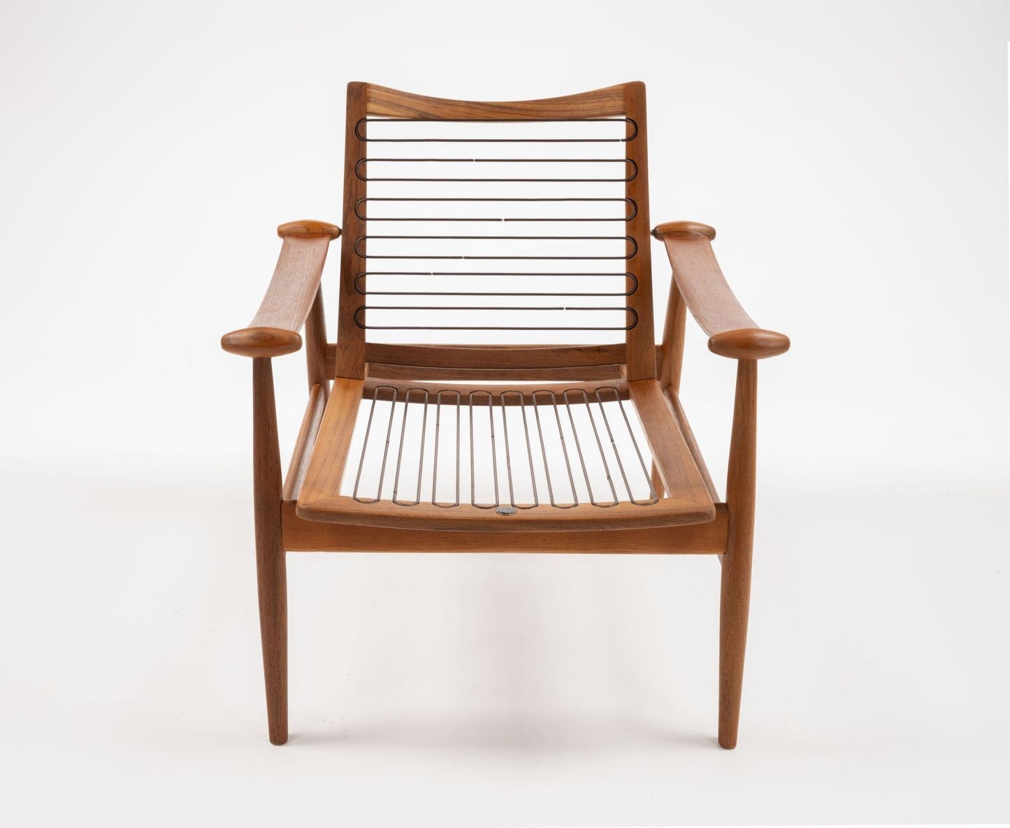 Model 133 Spade armchair by Finn Juhl, sculpted solid teak with curved armrests and slatted seat and backrest.
