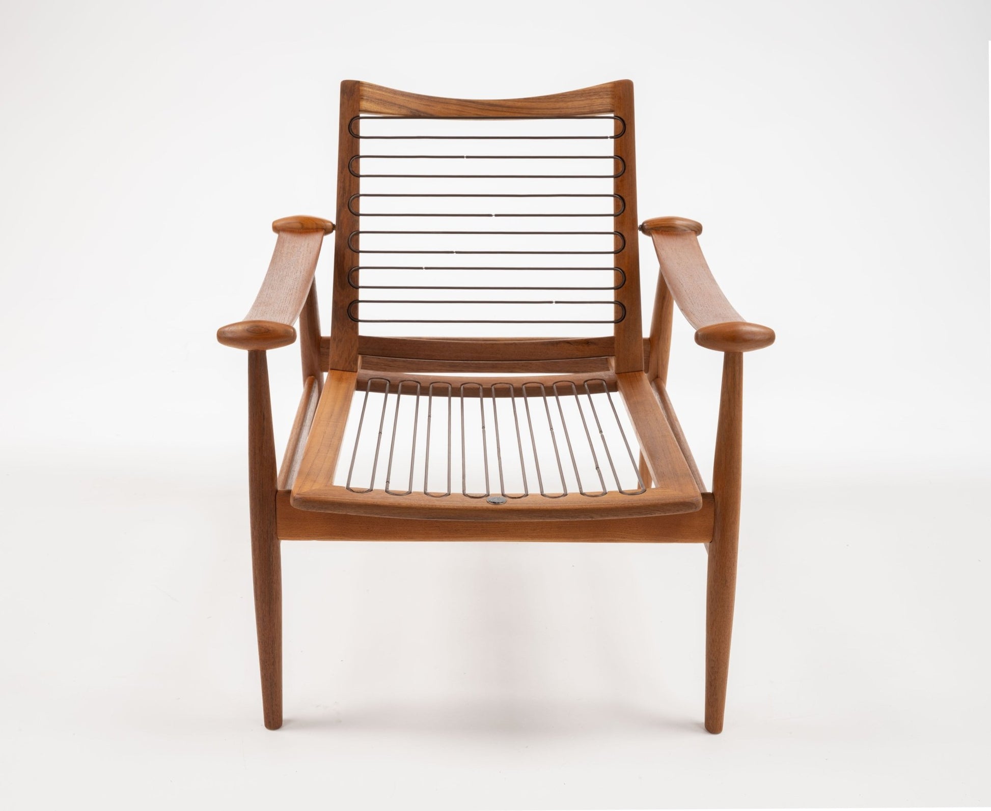 Model 133 Spade armchair by Finn Juhl, sculpted solid teak with curved armrests and slatted seat and backrest.