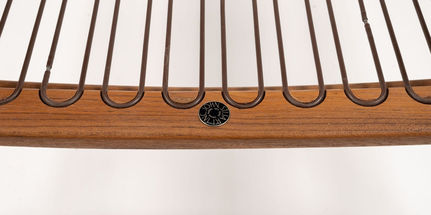Close-up of mid-century modern Finn Juhl Model 133 Spade Armchair’s teak wood frame with metal wire backrest detail