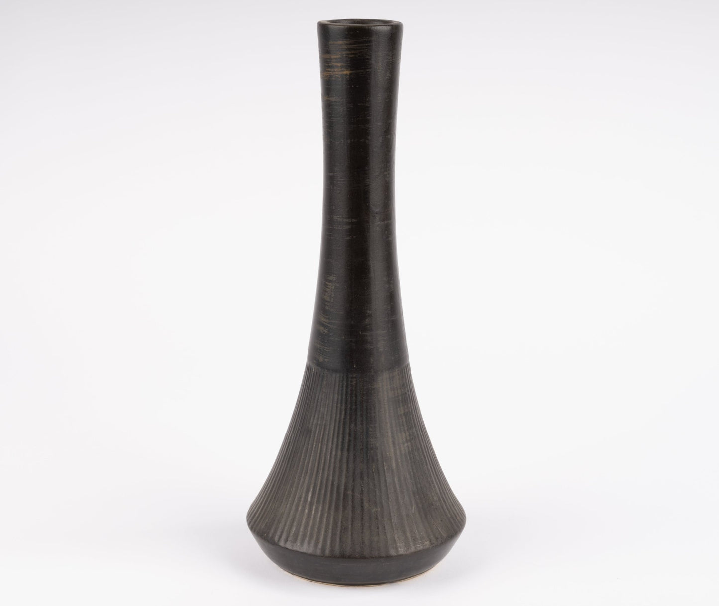 Tall Nelson McCoy pottery vase with slender neck and flared ribbed base in deep charcoal-black glaze