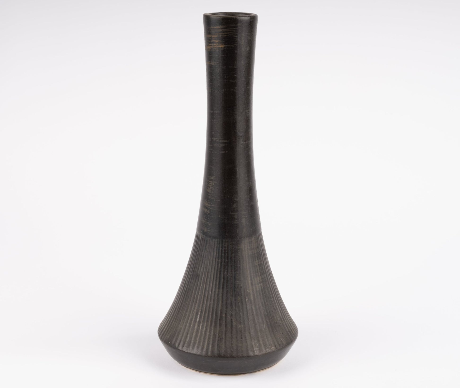 Tall Nelson McCoy pottery vase with slender neck and flared ribbed base in deep charcoal-black glaze