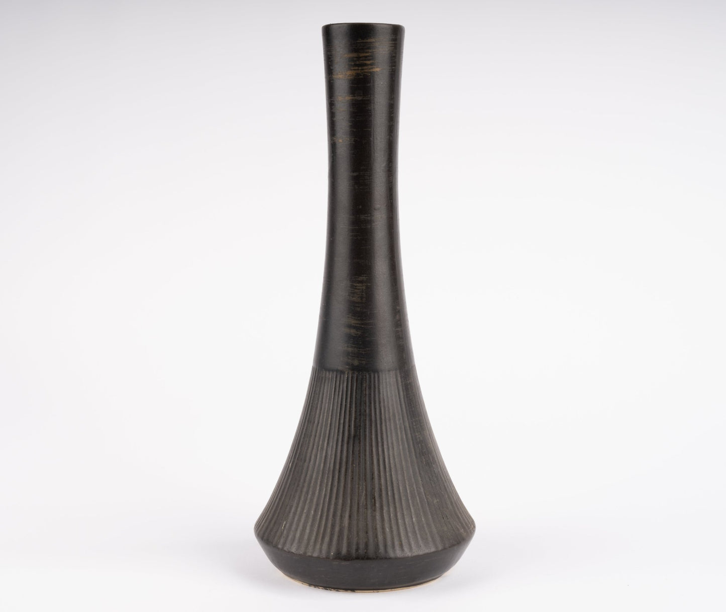 Tall Nelson McCoy pottery vase with slender neck and flared ribbed base in charcoal-black glaze
