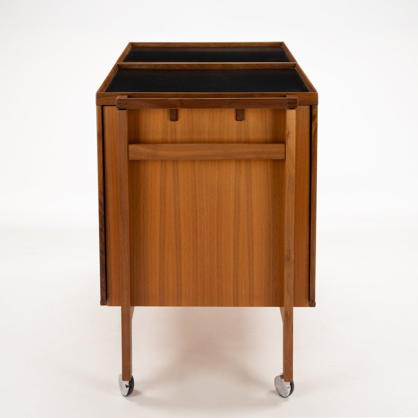 Niels Erik & Glasdam Jensen Teak Expanding Bar Cart displaying a rear view of warm teak wood with sleek clean lines, sturdy handle, and smooth caster wheels highlighting vintage Danish mid century modern storage design.