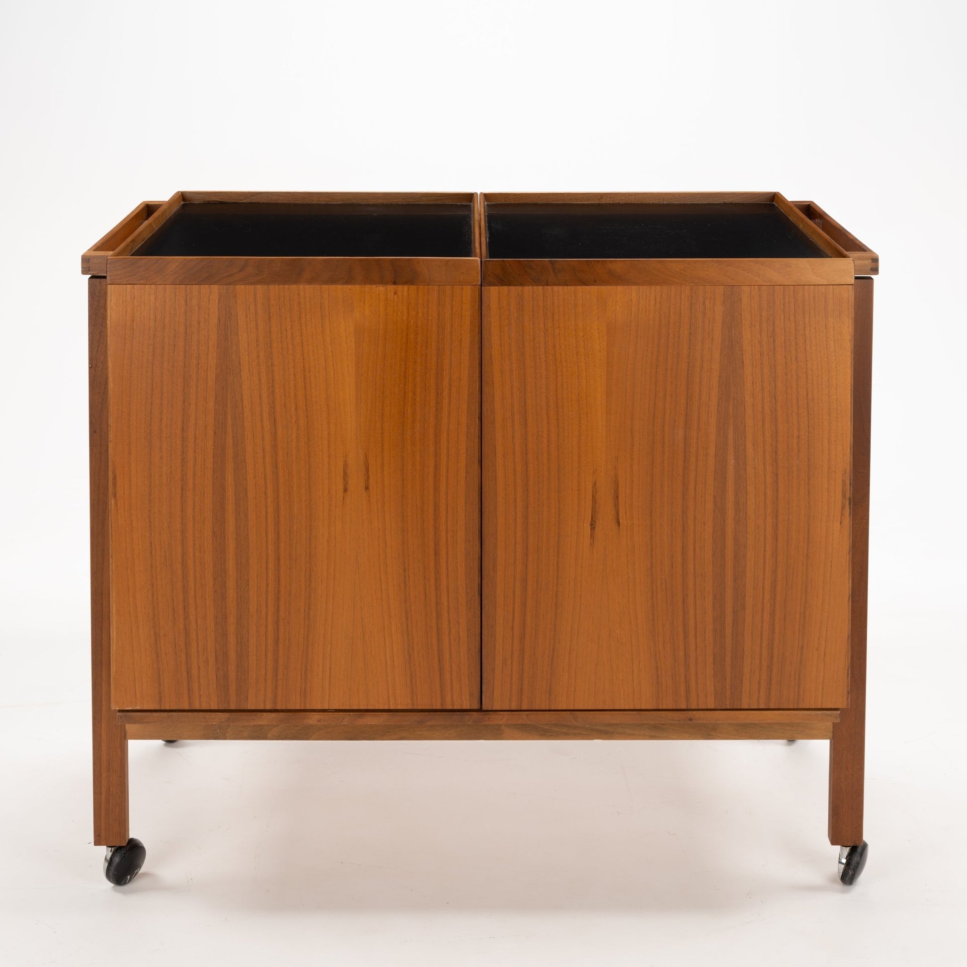 Niels Erik & Glasdam Jensen Teak Expanding Bar Cart featuring a warm teak finish, clean rectangular panels, and caster wheels for easy mobility in a vintage mid century modern style.