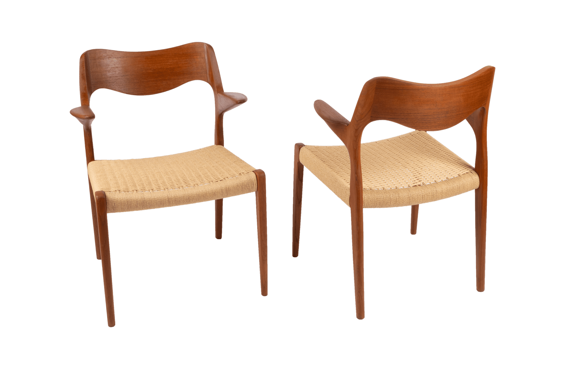 Pair of Niels Moller mid-century modern teak dining chairs with sculpted armrests and Danish cord seats on white background