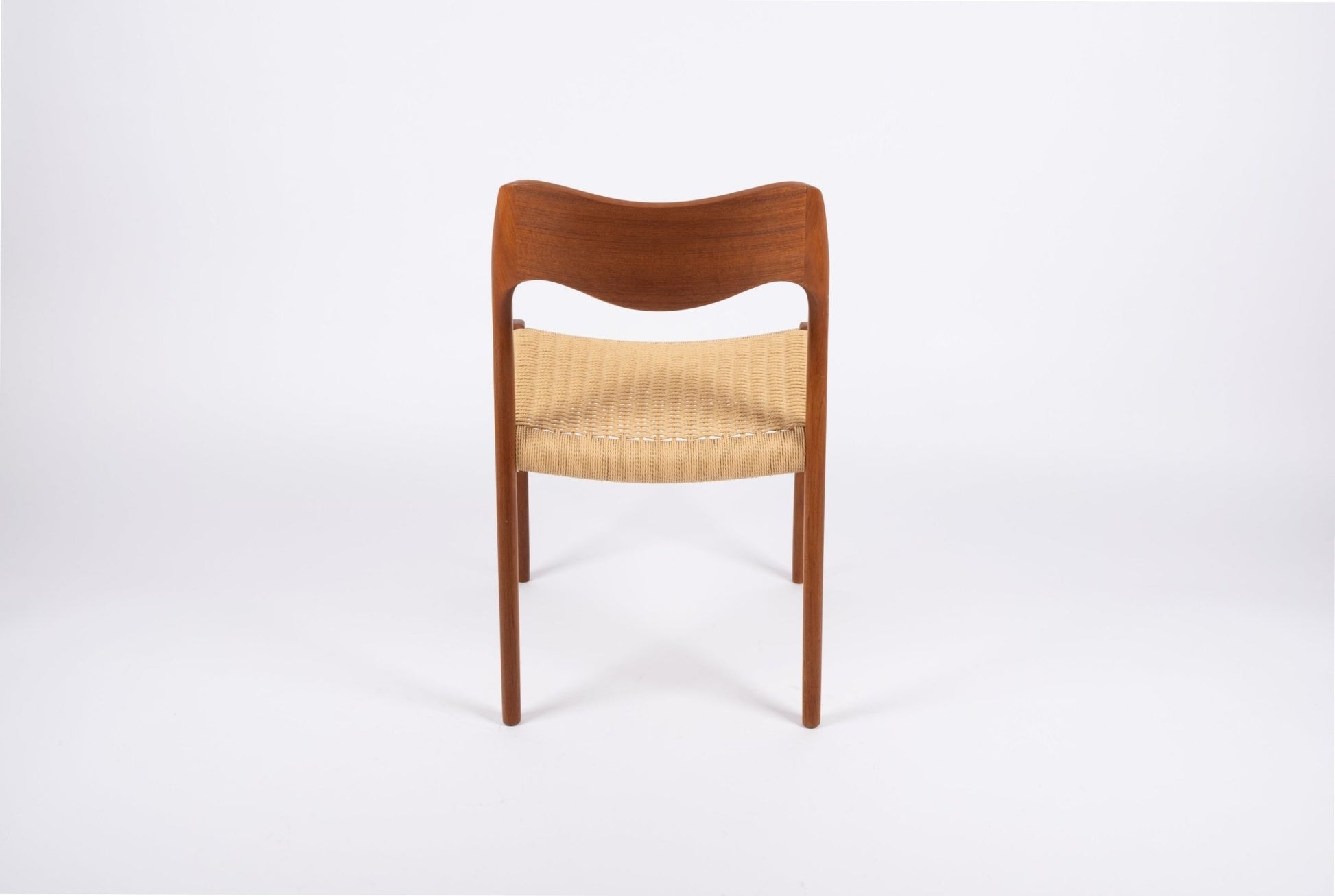 Mid-century modern Niels Moller dining chair in teak with Danish cord seat, curved backrest, and slender legs