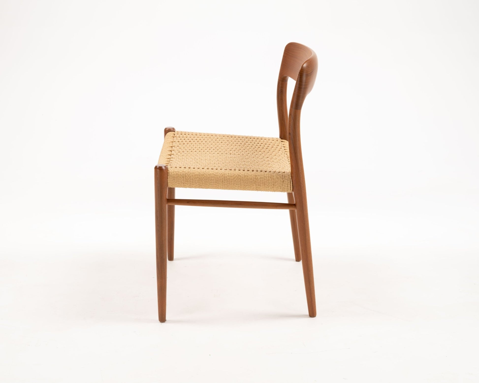Side view of Niels Otto Moller Model 56 teak dining chair with woven papercord seat from 1960s Denmark