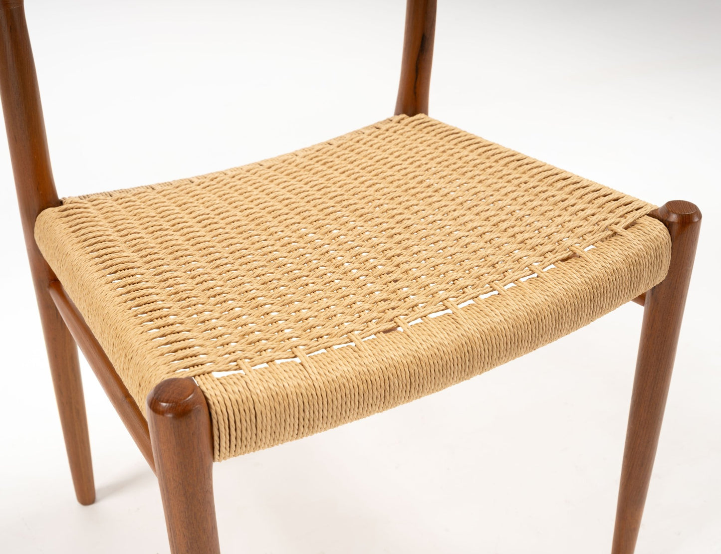 Close-up of woven papercord seat on Niels Otto Moller teak dining chair from the 1960s Danish design set of six