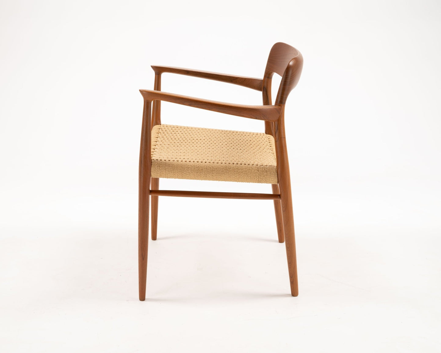 Side view of Niels Otto Moller solid teak dining chair with woven papercord seat from 1960s Denmark