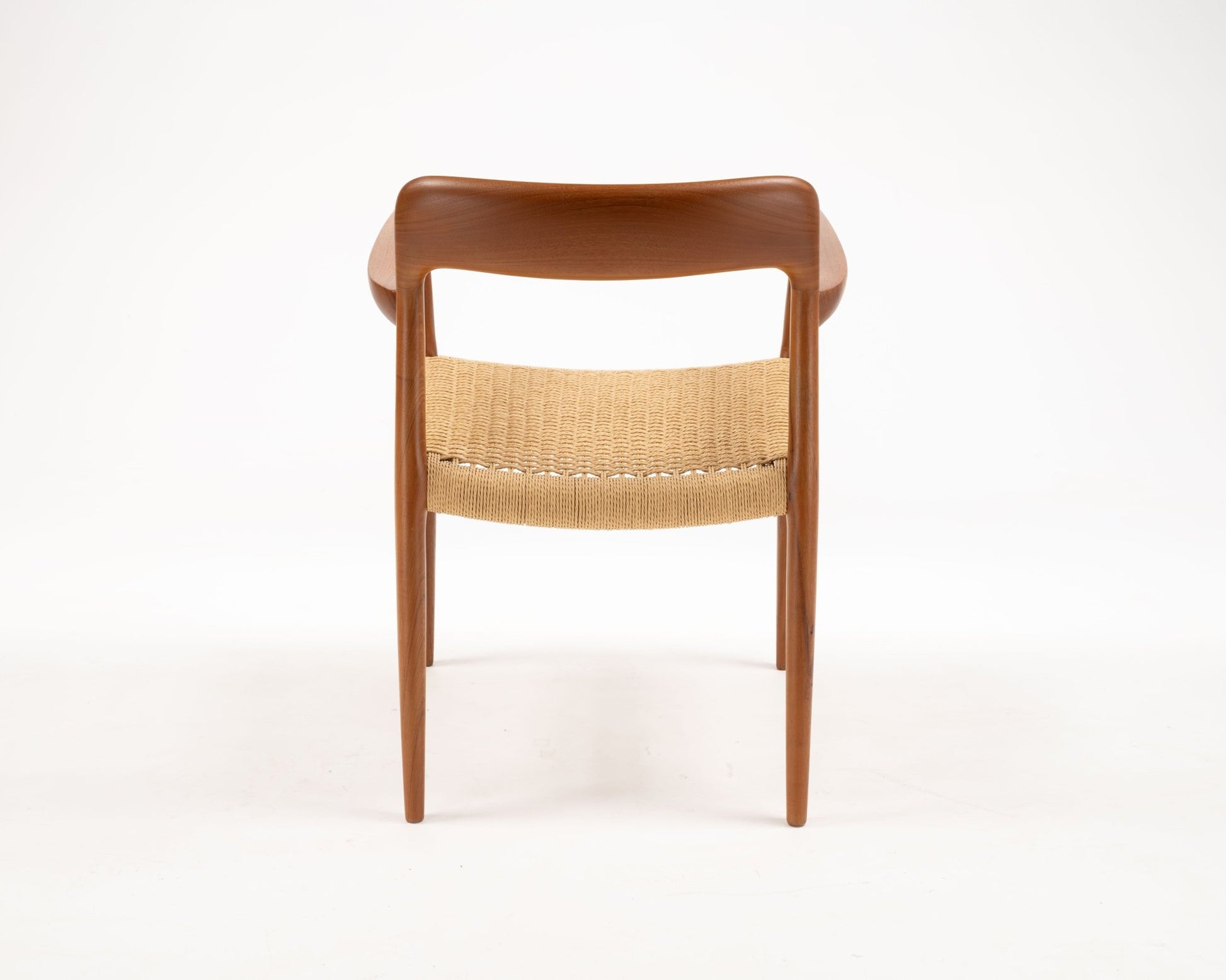 Rear view of Niels Otto Moller Model 56 dining chair in solid teak with woven papercord seat from 1950s Denmark