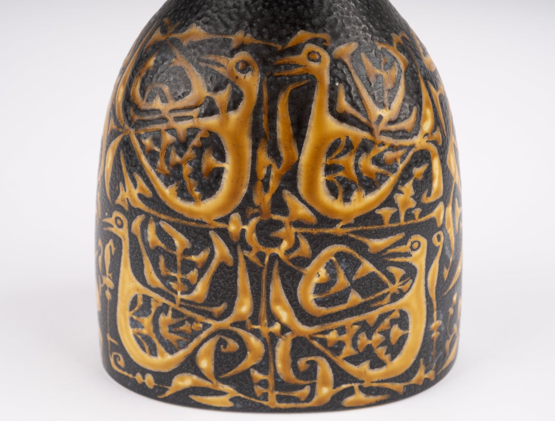 Close-up of Nils Thorsson fajance vase with intricate raised bird and floral pattern, mid-century Danish ceramic design