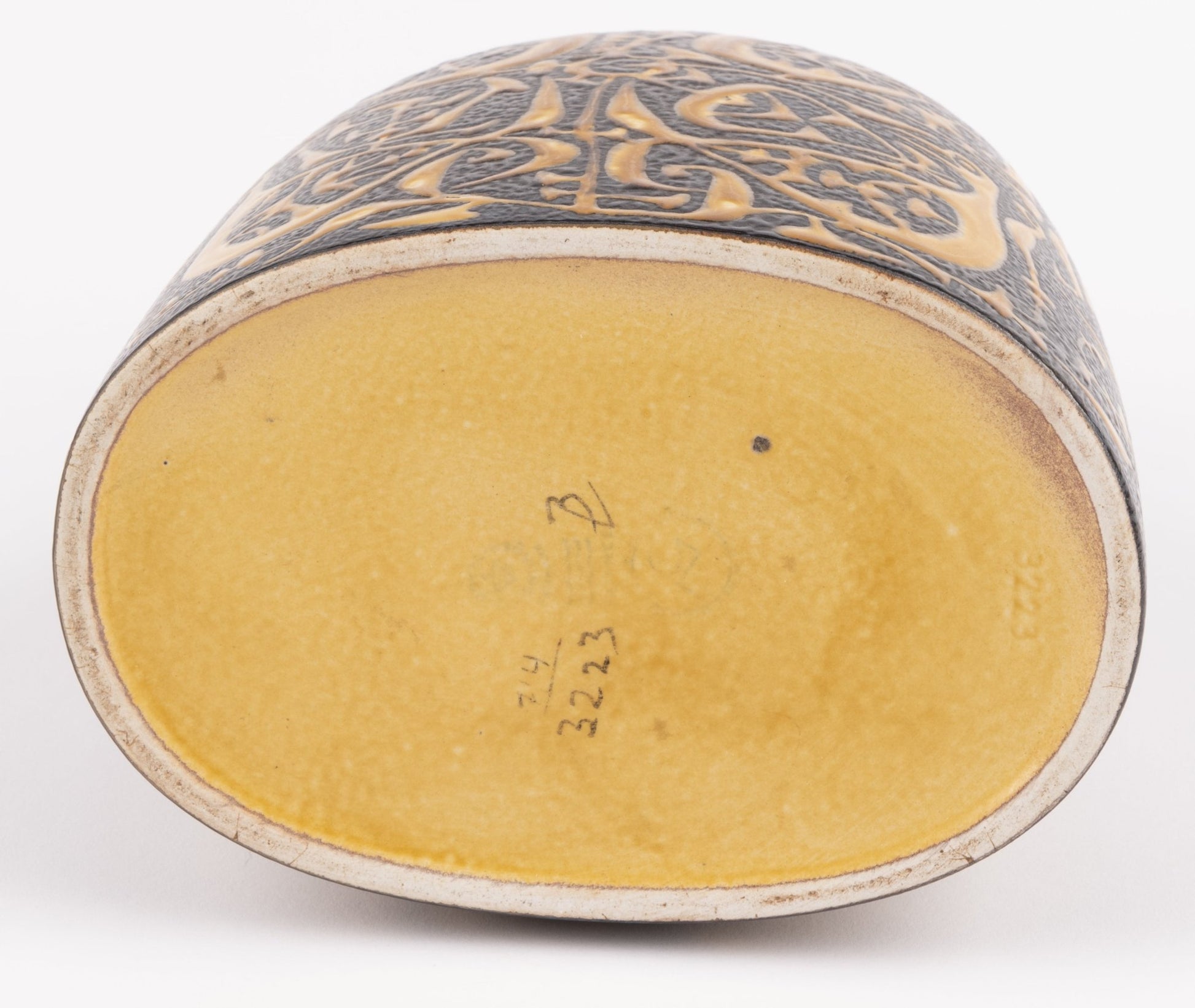 Base view of Nils Thorsson fajance vase showing stamped Royal Copenhagen marks and textured yellow glaze interior