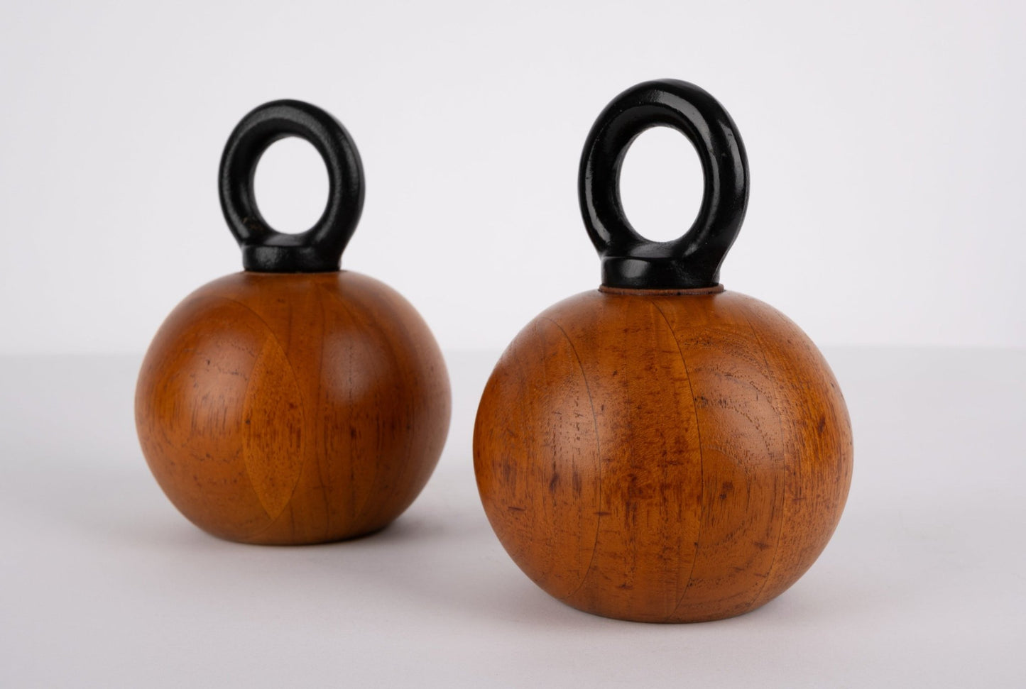 Pair of 1960s Nissen & Jorgensen Danish salt and pepper mills with solid teak bodies and rounded black iron handles