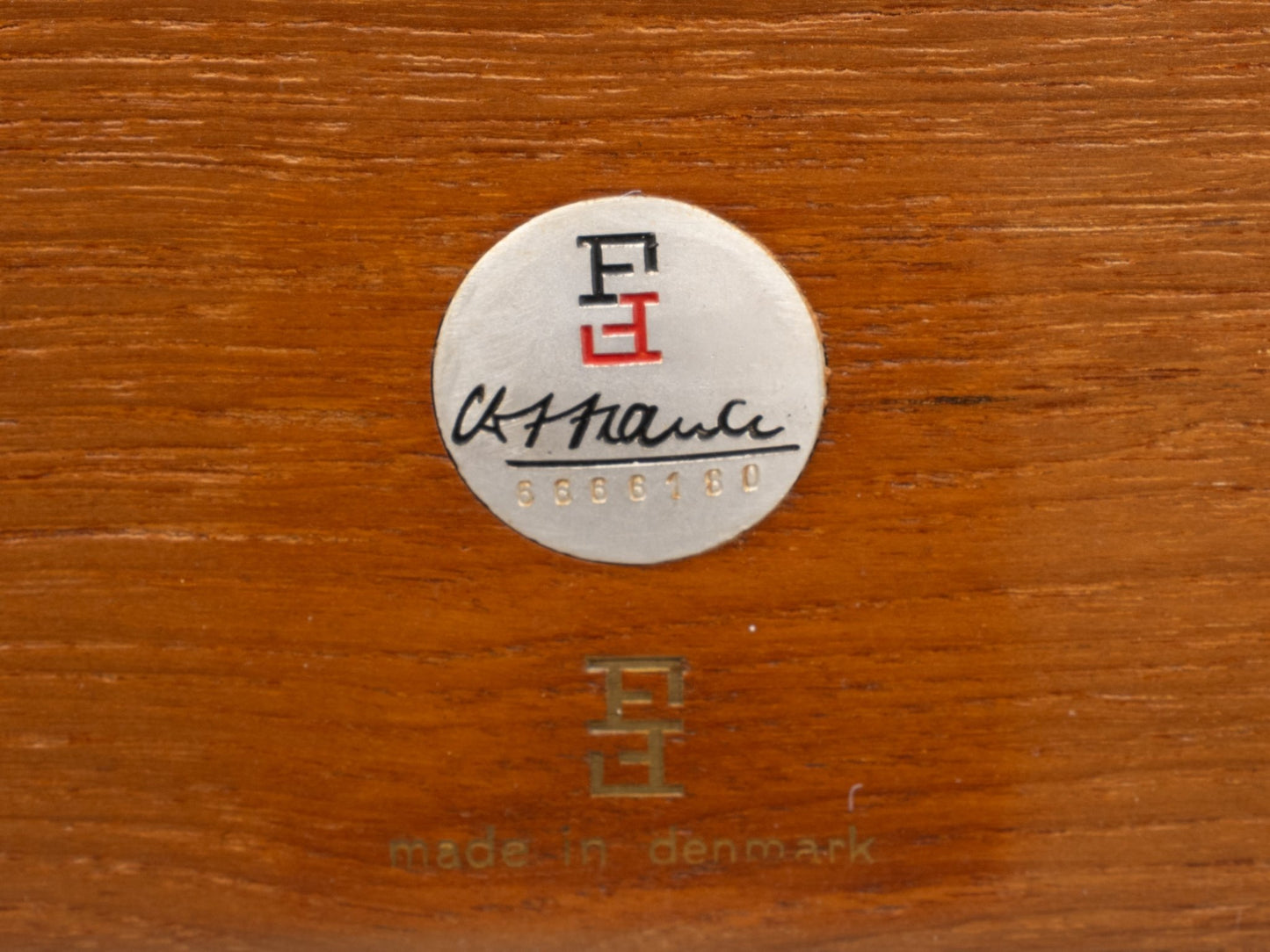 Close-up of France & Son label and Ole Wanscher signature on teak wood, marked made in Denmark, circa 1960s.
