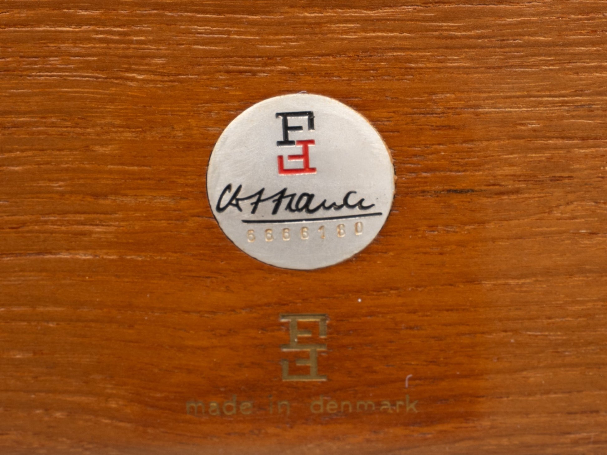 Close-up of France & Son label and Ole Wanscher signature on teak wood, marked made in Denmark, circa 1960s.