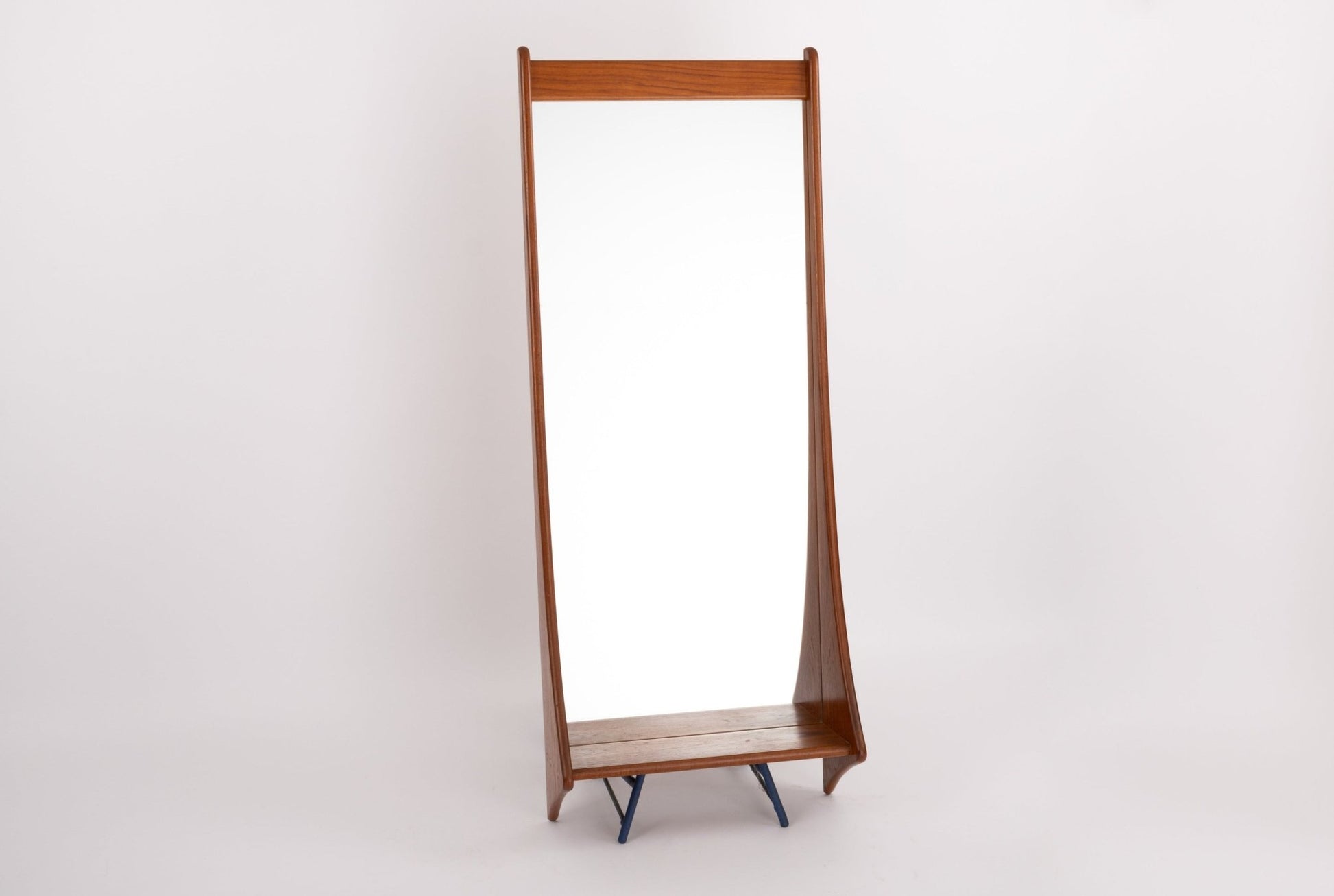 Pedersen & Hansen teak wall mirror from 1960s with sculpted frame and tapered legs on white background