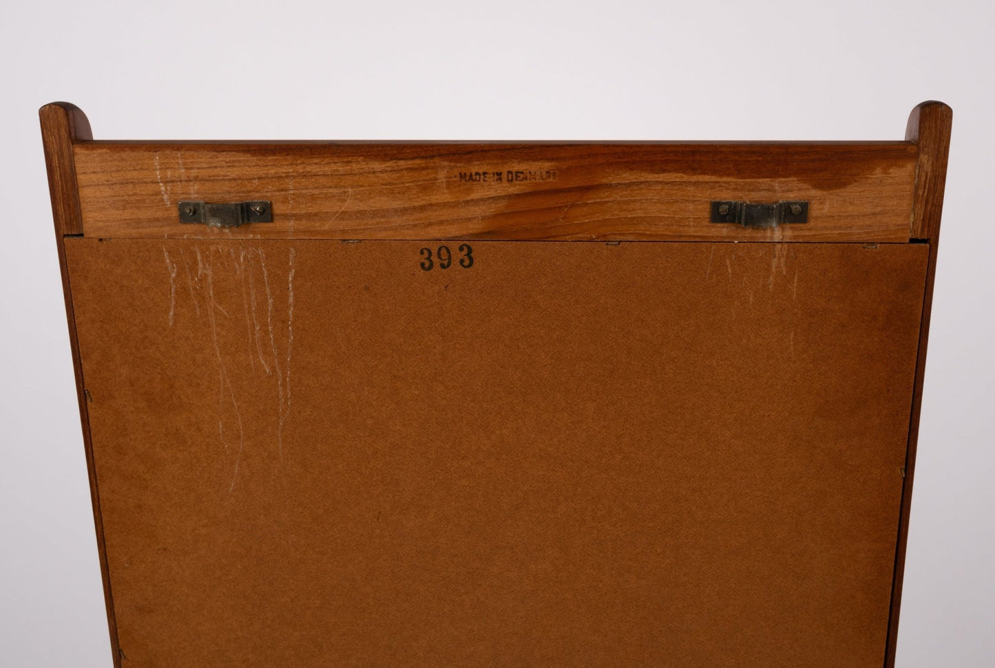 Back view of 1960s Pedersen & Hansen teak wall mirror showing metal eyes, maker's mark, and wooden frame details.