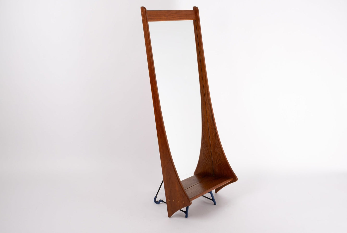 Pedersen & Hansen 1960s teak wall mirror with sculpted frame and dowel details, standing on metal legs.