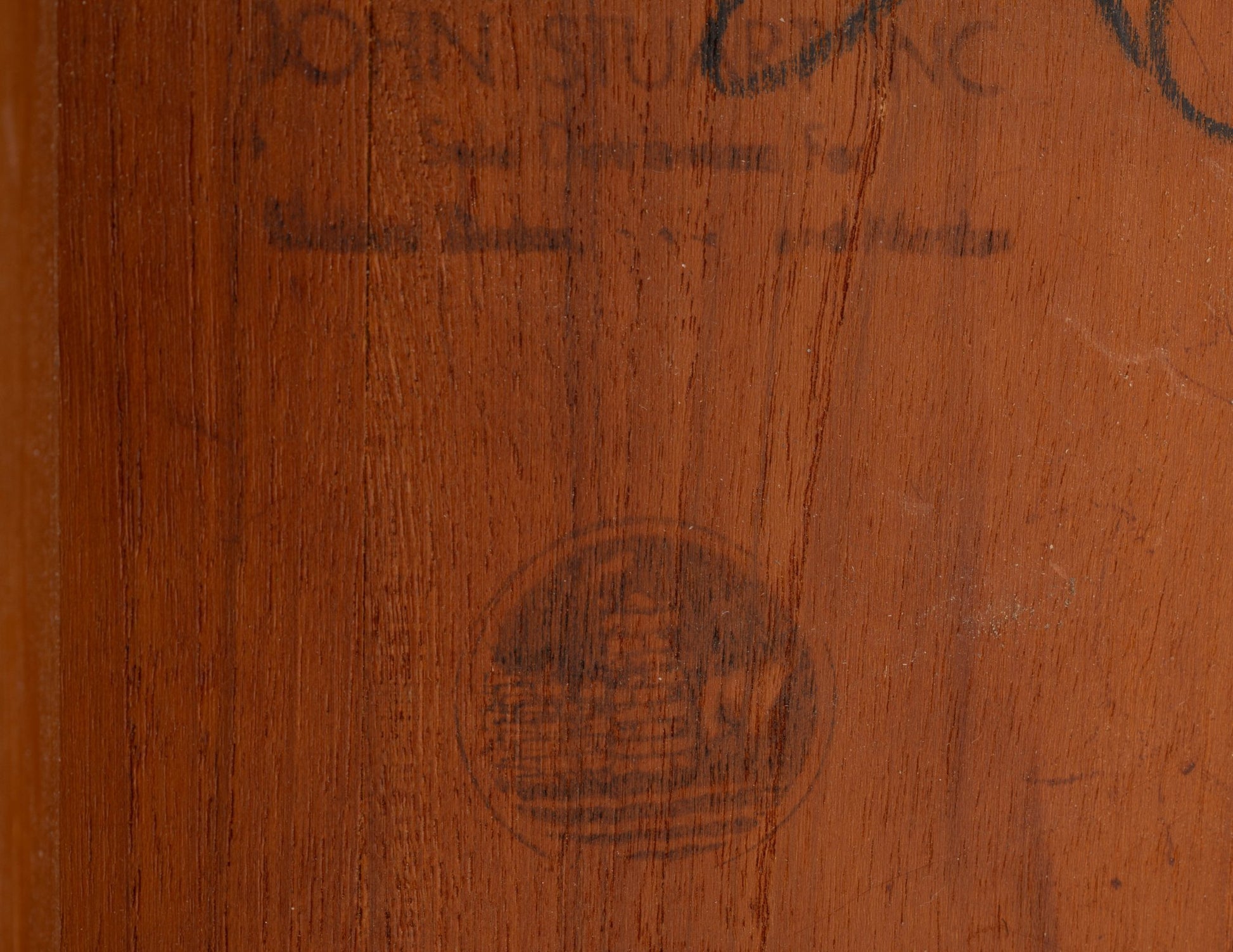 Close-up of Peter Hvidt Model 311 extendable dining table teak wood surface with faint Maker’s mark stamp.