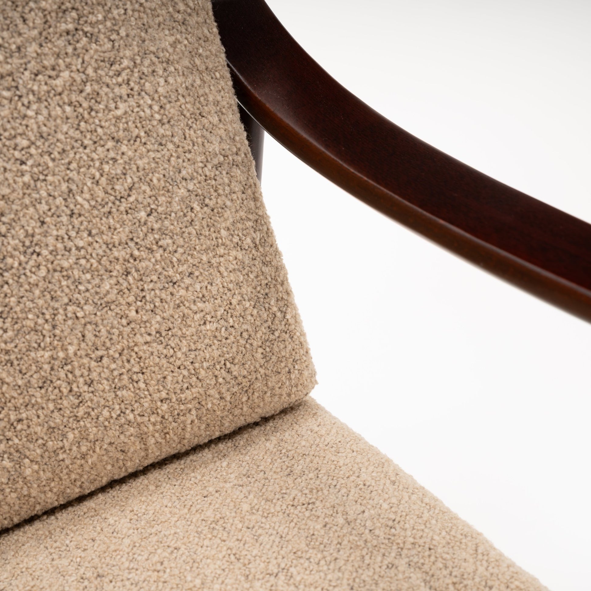 Peter Hvidt Model FD 145 Lounge Chair close view of beige textured upholstery and curved dark wood arm in vintage Danish furniture style